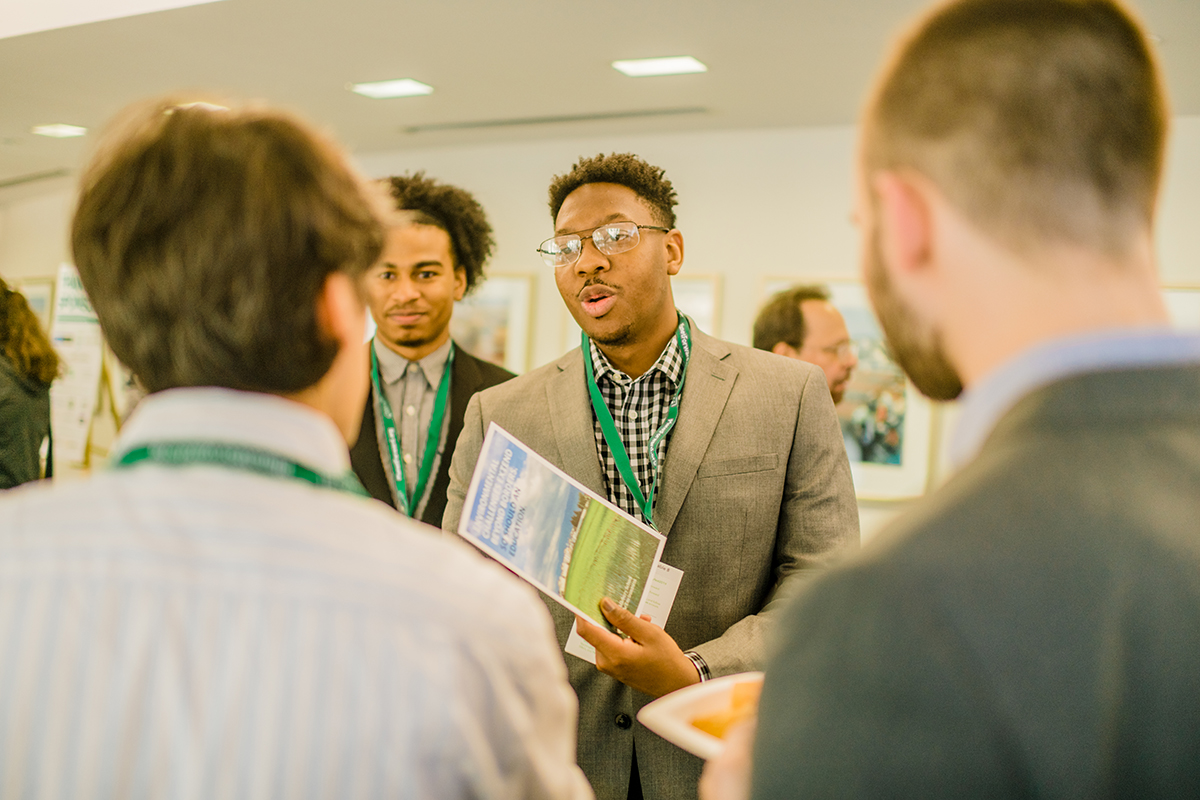 At the networking break Claflin University students Justus Mitchell, left, and Darian Hughes, chat with professors.